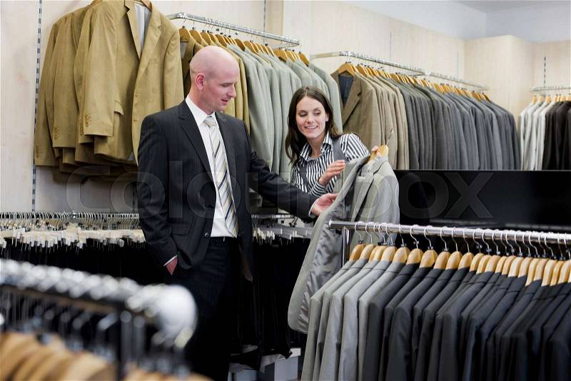 Man and woman in clothing store, stock photo