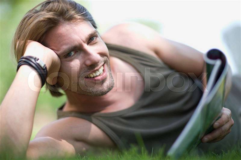 Man lying in the lawn, stock photo