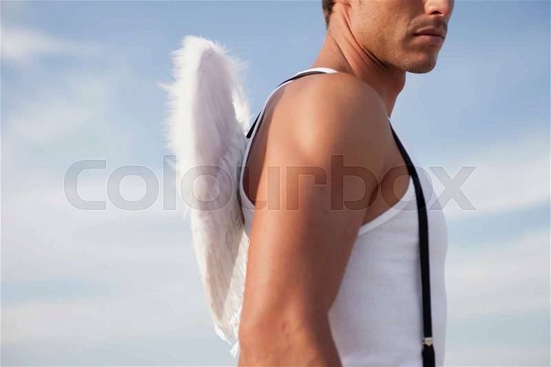 Man wearing angel\'s wings, stock photo