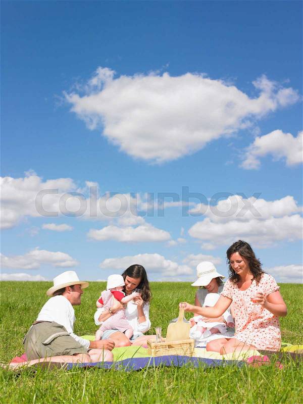 Young people on picnic blanket, stock photo