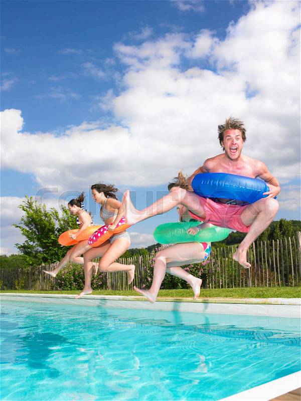 People jumping into pool, stock photo