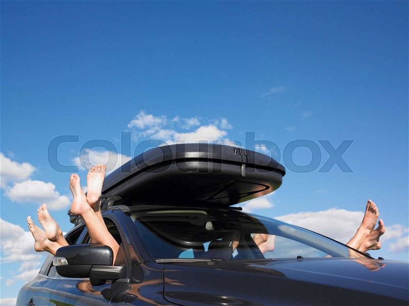 Feet out of car window, stock photo