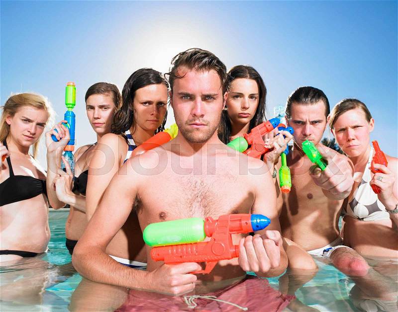 Young people posing with water guns, stock photo