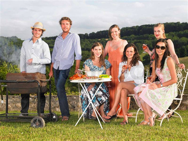 Young people having barbecue, stock photo