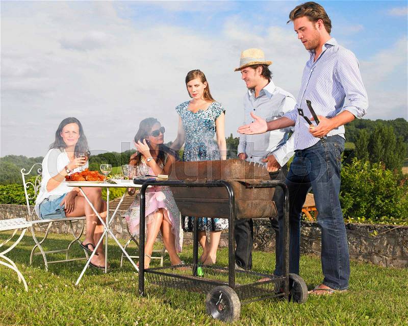 Young people having barbecue, stock photo