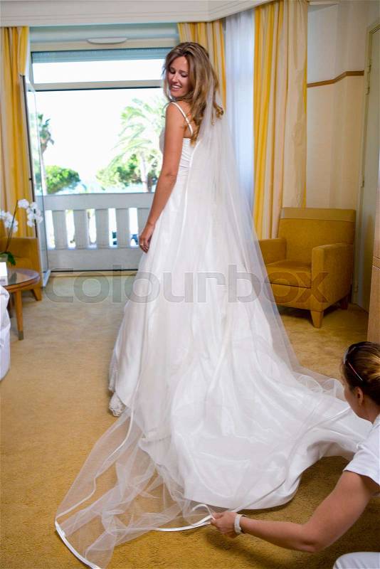 Bride gets dressed, stock photo