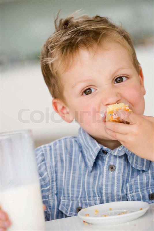 Young boy eating sweet dumpling, stock photo