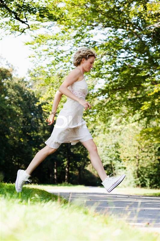 Woman running in park, stock photo