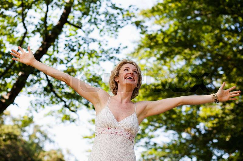 Woman with arms wide open, stock photo