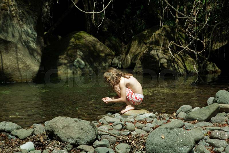 Girl holding water in hand, stock photo