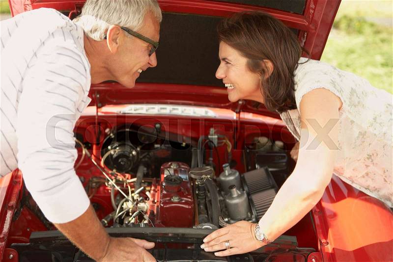 Couple with car, fixing engine, stock photo