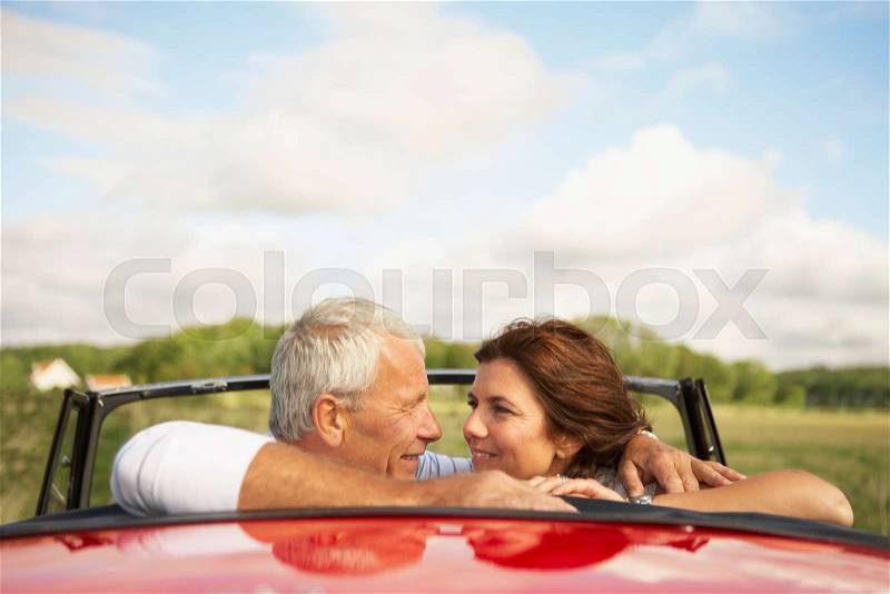 Couple in car, over shoulder, stock photo