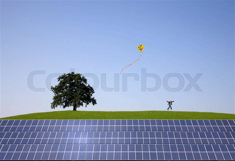 Man jumping at solar power panels, stock photo