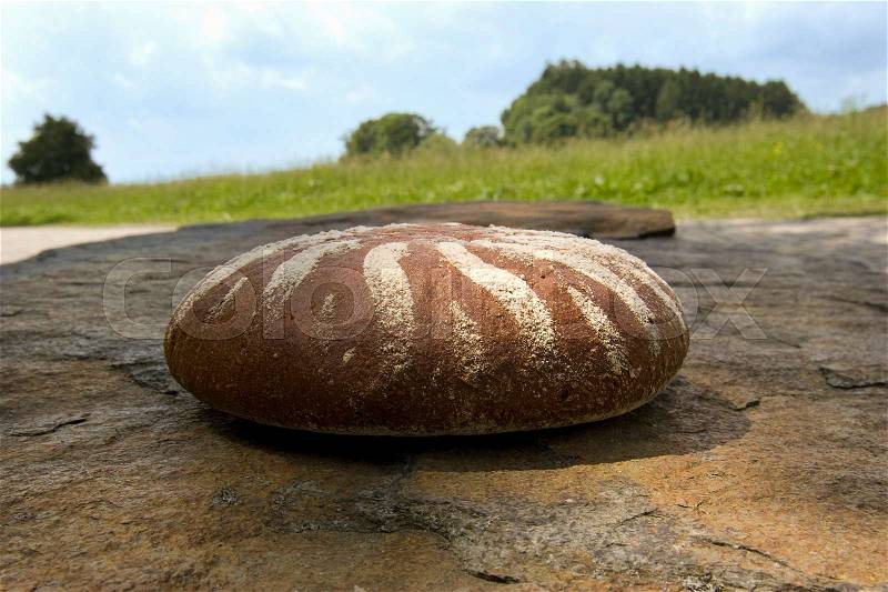 Bread on a stone in beautiful landscape, stock photo