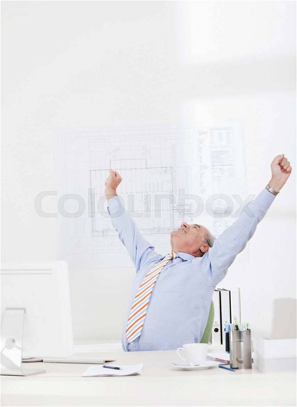 Man celebrating, stretching arms, stock photo
