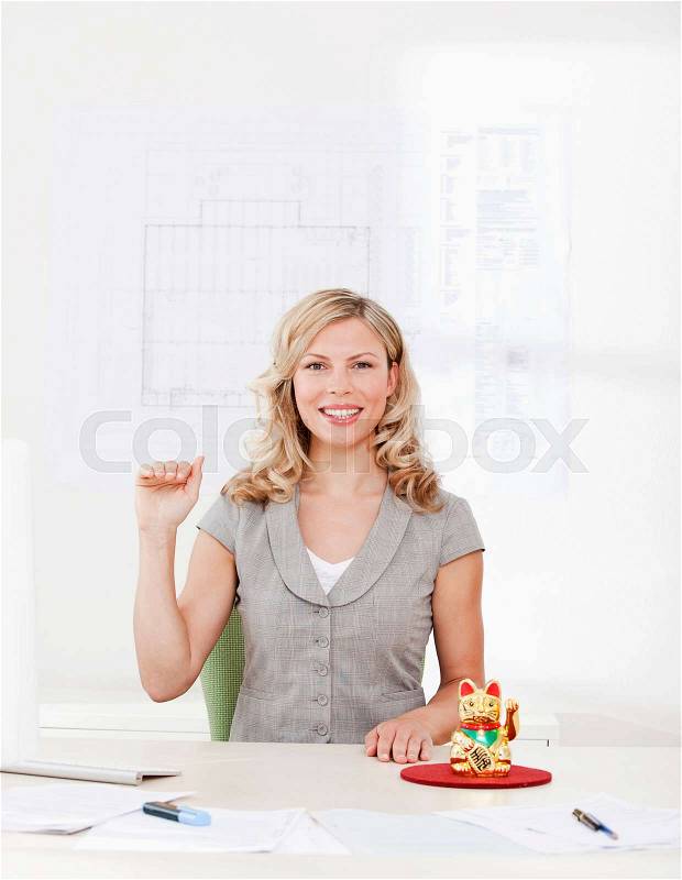 Businesswoman with good luck charm, stock photo