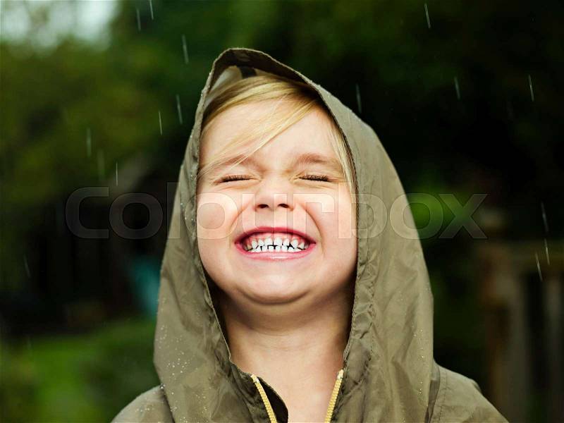Girl smiling while it rains, stock photo