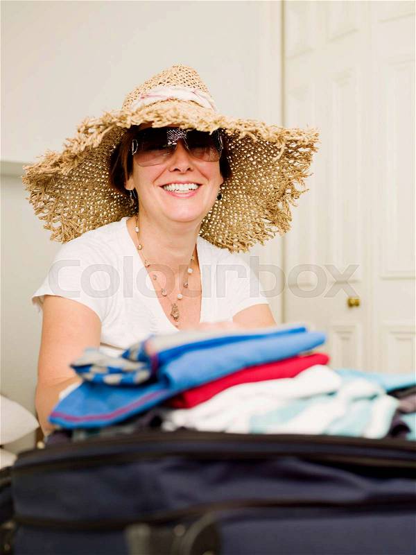 A female packing to go on holiday, stock photo