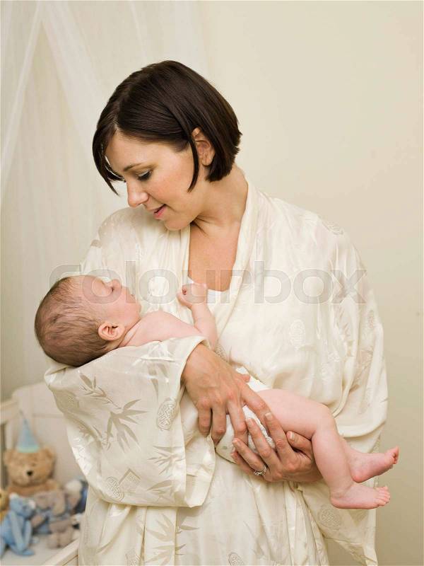 A mother holding a new born baby, stock photo