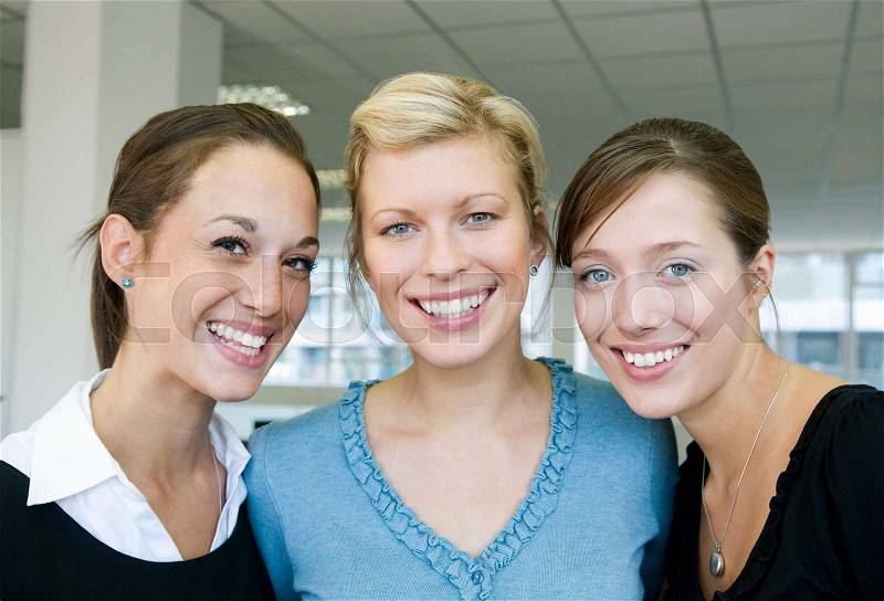 Three female business colleagues smiling, stock photo