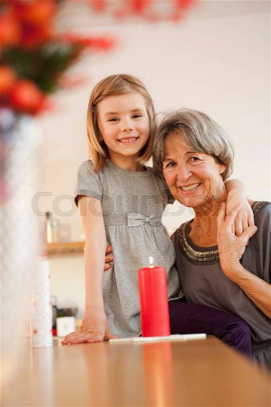 Grandchild and grandma with candle, stock photo