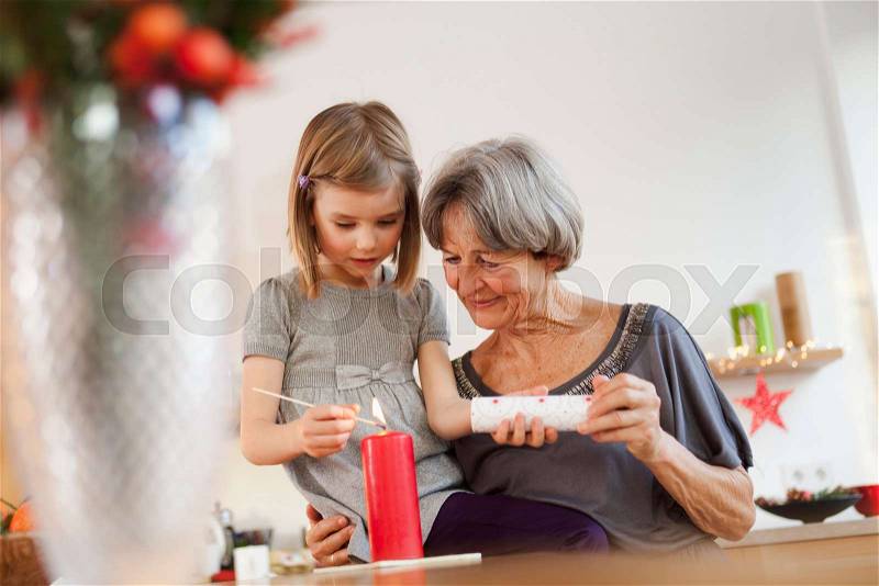 Grandchild and grandma with candle, stock photo