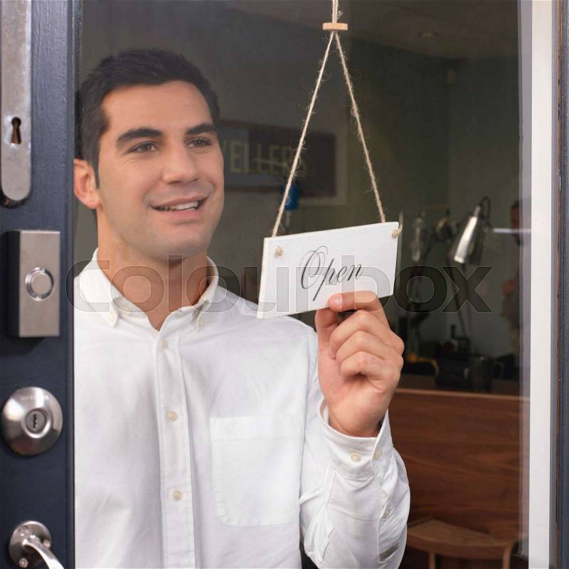 Man at door saying \'open\', stock photo