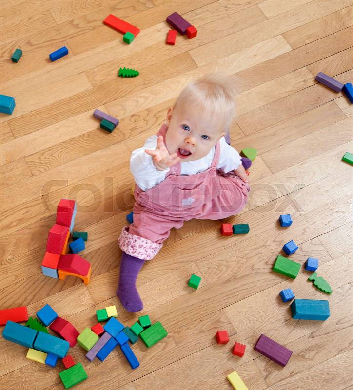 Baby with toy building blocks, stock photo