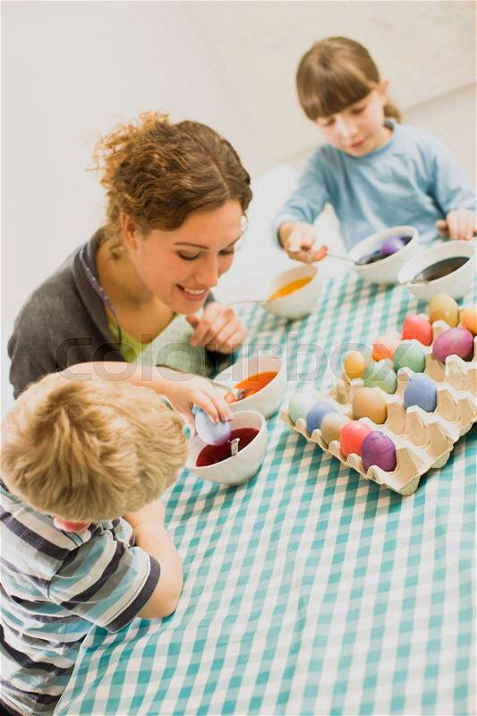 Family doing Easter arrangements, stock photo