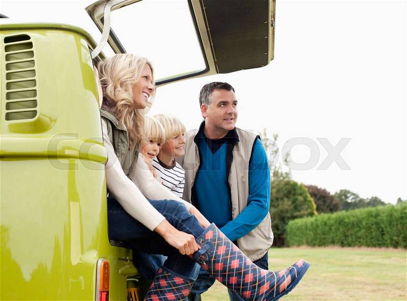 Family at back of camper van, stock photo