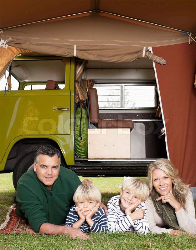 Family in front of camper van, stock photo