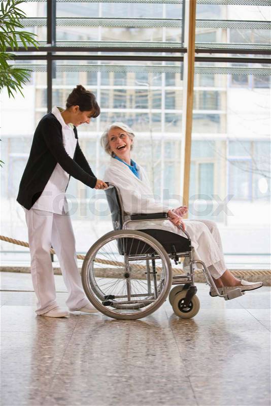 Old woman in a wheel chair and nurse, stock photo