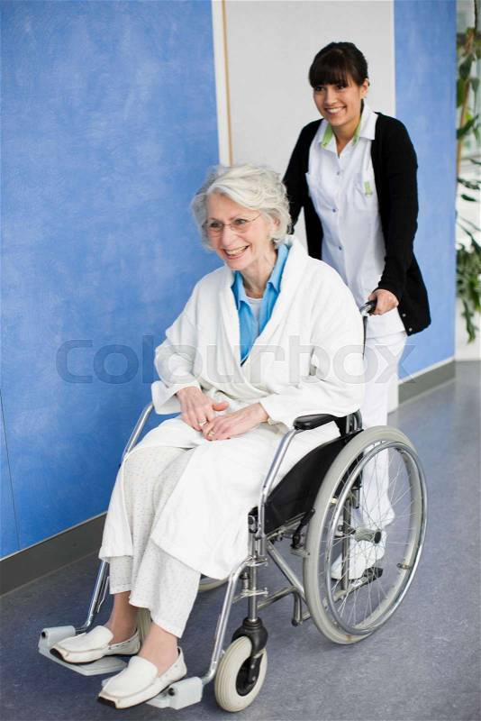 Old woman in a wheel chair and nurse, stock photo