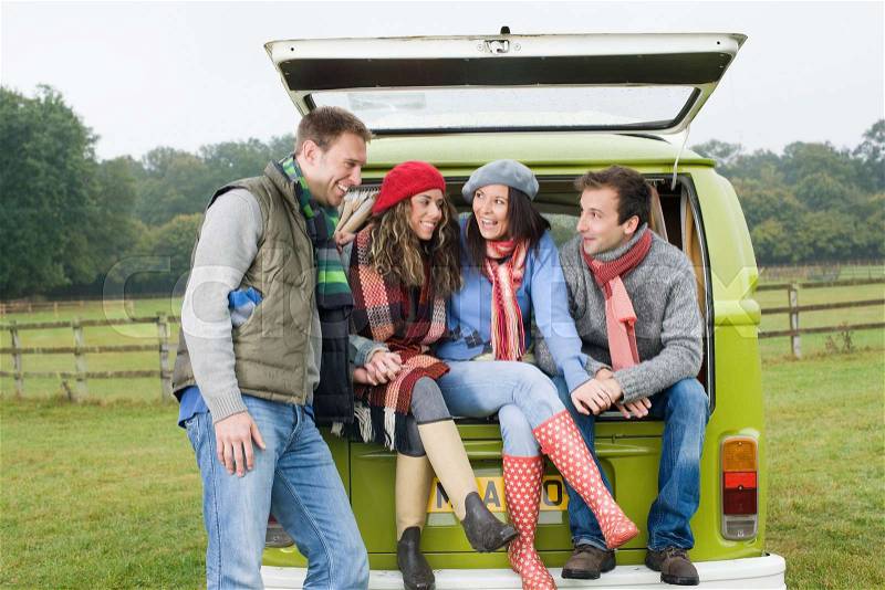 Couples at back of camper van, stock photo
