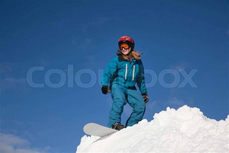 Girl snowboarding, stock photo