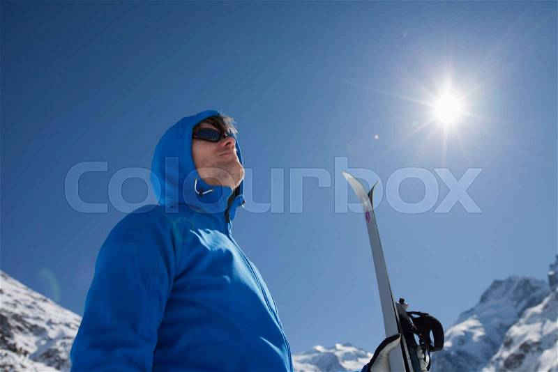 Man with cross-country ski in winter, stock photo