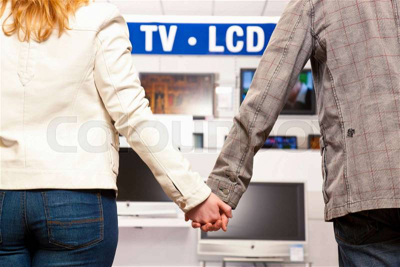 Couple buying new TV, stock photo