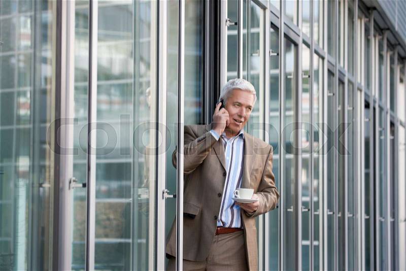 On the phone during the coffee break, stock photo
