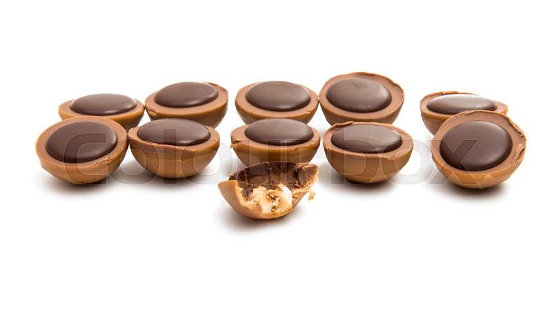 Chocolate truffle with nut on white background, stock photo