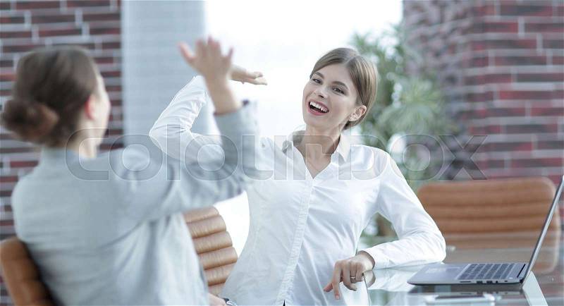 Members of the business team happy to the results and giving a high five, stock photo