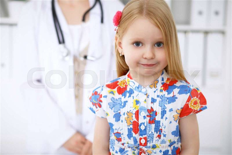 Happy cute baby after health exam at doctor\'s office, stock photo