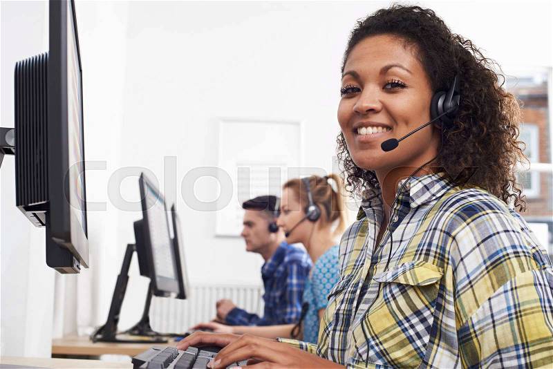 Female Customer Services Agent In Call Centre, stock photo