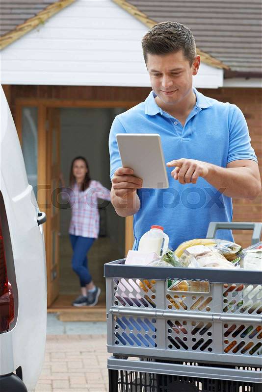 Driver Delivering Online Grocery Order To House, stock photo