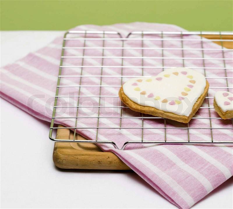 Heart-shaped cookies on baking rack, stock photo