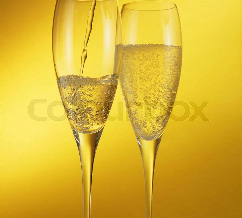 Champagne flow in champagne glasses, stock photo