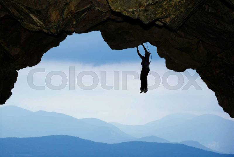 Man rock climber silhouette concepts of Courage and Adventure, stock photo