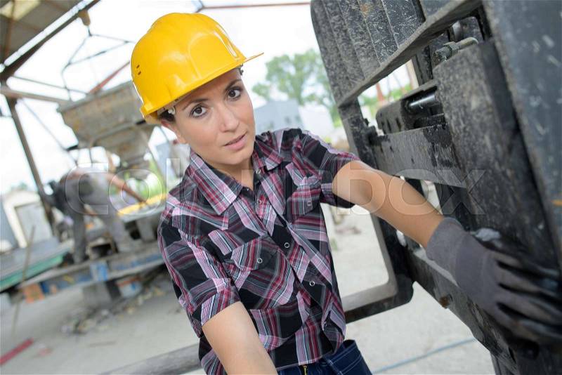 Portrait of happy female construction worker at site, stock photo