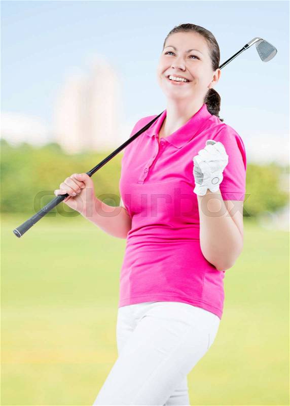 Joyful woman golfer enjoys his victory on a background of golf courses, stock photo