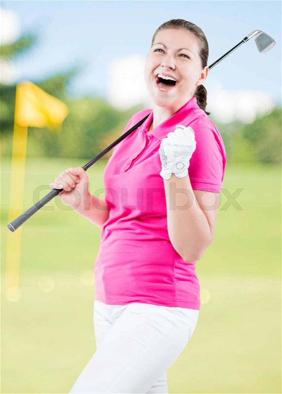Happy golfer jubilant on a background of golf courses with a golf club, stock photo