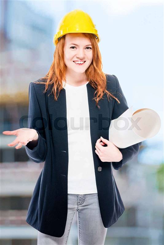 Vertical portrait of a senior architect woman with drawings in a yellow helmet, stock photo